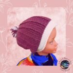 Bonnet bicolor crocheté artisanal, chaud, tendance avec pompon, couleur douce, adaptable et durable pour un hiver stylé et cocooning.